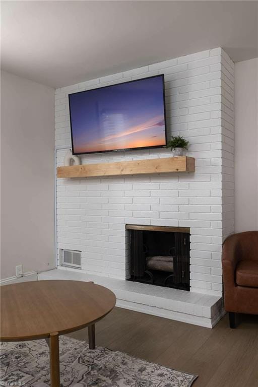 living room with a fireplace and hardwood / wood-style floors