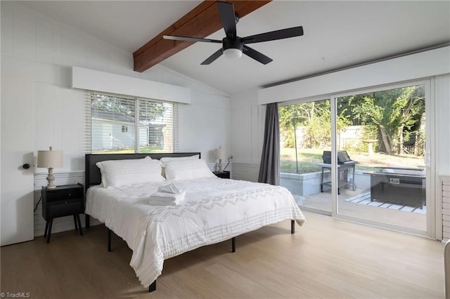 bedroom with access to exterior, ceiling fan, multiple windows, and hardwood / wood-style flooring