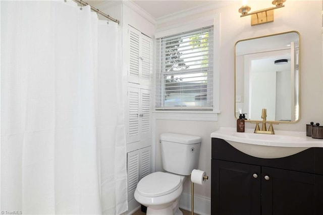 bathroom with vanity, toilet, and ornamental molding