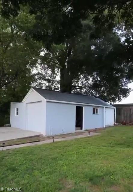 view of outdoor structure with a yard and a garage