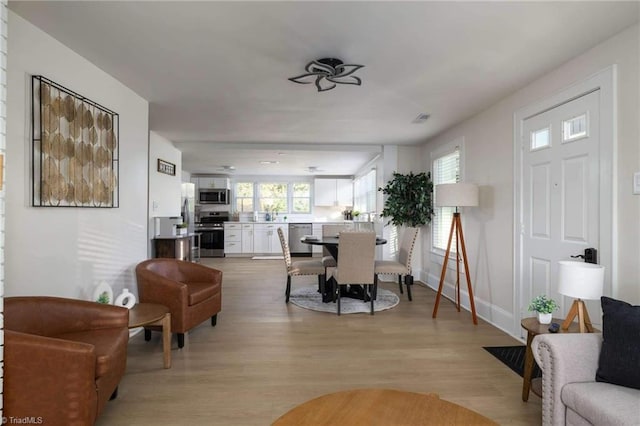 dining space with light hardwood / wood-style floors