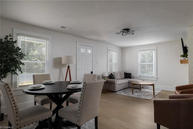 dining space with light hardwood / wood-style floors