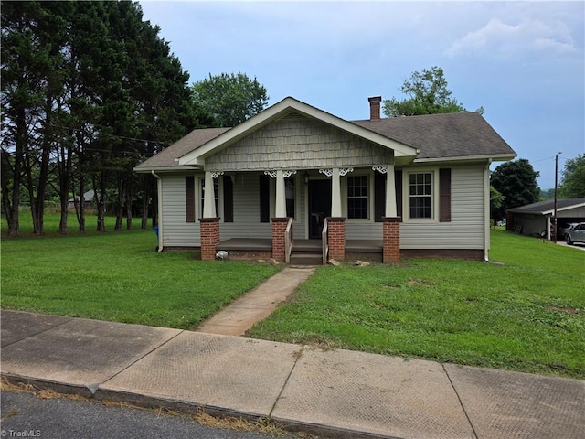 117 Hillcrest St, Jonesville, NC 28642 - bungalow-style house featuring a porch, a front lawn, and a chimney