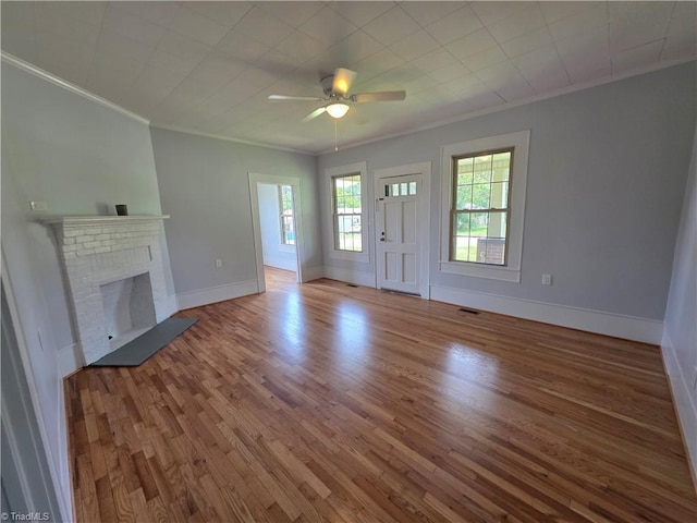 117 Hillcrest St, Jonesville, NC 28642 - unfurnished living room featuring crown molding, wood finished floors, ceiling fan, and a fireplace