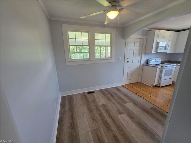 117 Hillcrest St, Jonesville, NC 28642 - kitchen with white appliances, crown molding, white cabinetry, arched walkways, and healthy amount of natural light