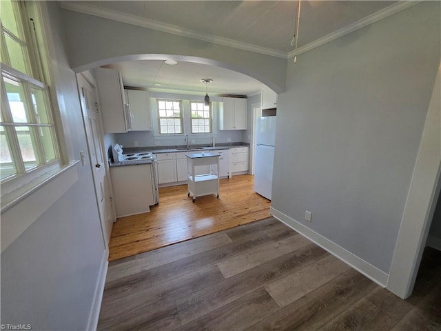117 Hillcrest St, Jonesville, NC 28642 - kitchen featuring ornamental molding, arched walkways, light wood finished floors, white appliances, and white cabinetry