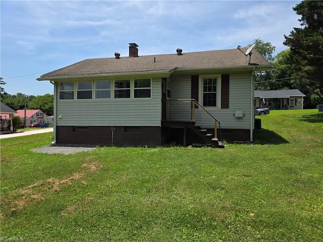 117 Hillcrest St, Jonesville, NC 28642 - rear view of house featuring a yard, a chimney, and a shingled roof