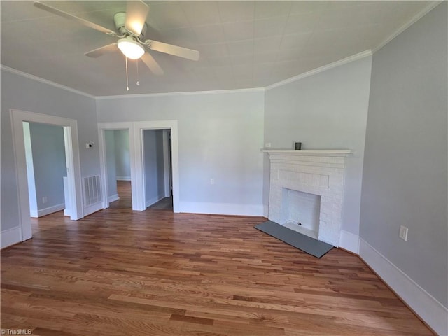 117 Hillcrest St, Jonesville, NC 28642 - unfurnished living room featuring ceiling fan, wood finished floors, ornamental molding, and a brick fireplace