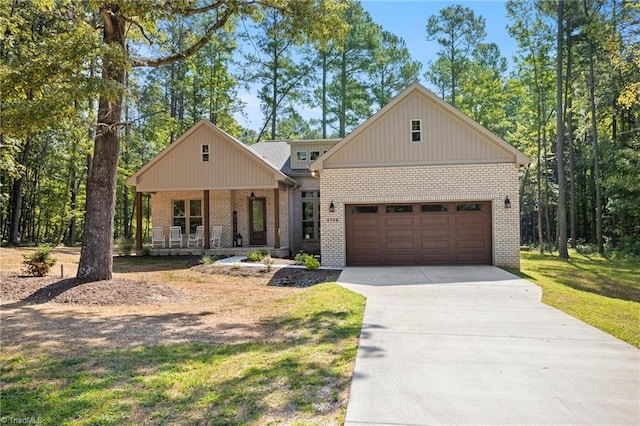 modern inspired farmhouse with a front yard and covered porch