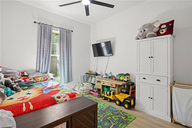 bedroom with ceiling fan and light wood-type flooring