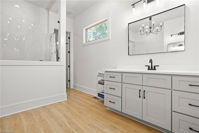 bathroom featuring vanity, hardwood / wood-style flooring, and walk in shower