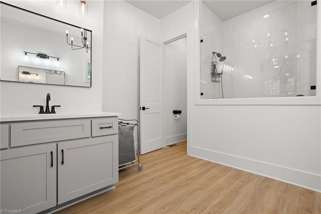 bathroom featuring vanity, hardwood / wood-style flooring, and walk in shower