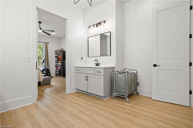 bathroom featuring hardwood / wood-style flooring, vanity, and ceiling fan