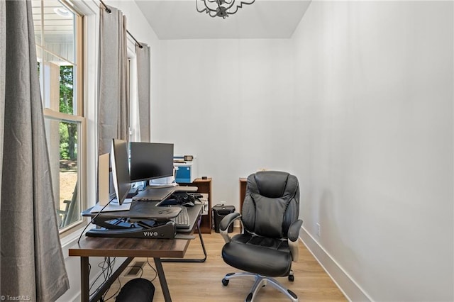 office featuring a chandelier and light hardwood / wood-style flooring