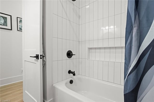 bathroom with wood-type flooring and shower / tub combo with curtain