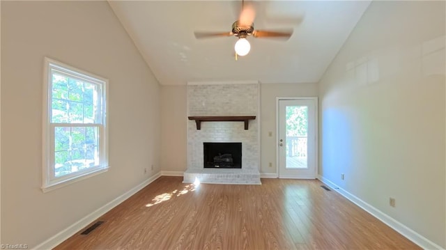 3128 Burke Mill Ct, Winston-Salem, NC 27103 - unfurnished living room with vaulted ceiling, healthy amount of natural light, wood finished floors, ceiling fan, and a brick fireplace
