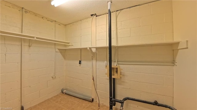 3128 Burke Mill Ct, Winston-Salem, NC 27103 - washroom featuring concrete block wall and a textured ceiling