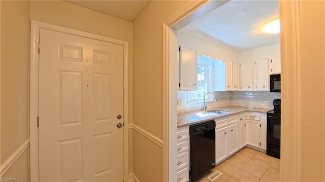 3128 Burke Mill Ct, Winston-Salem, NC 27103 - kitchen featuring black appliances, backsplash, white cabinetry, light stone counters, and light tile patterned floors