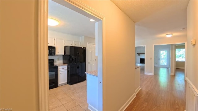 3128 Burke Mill Ct, Winston-Salem, NC 27103 - corridor featuring a textured ceiling and light wood-type flooring