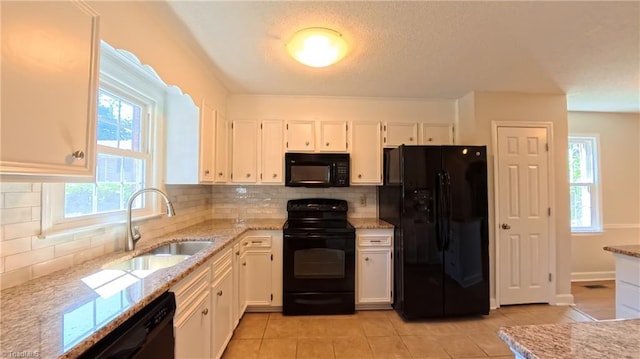 3128 Burke Mill Ct, Winston-Salem, NC 27103 - kitchen featuring black appliances, light stone countertops, white cabinets, light tile patterned floors, and a textured ceiling
