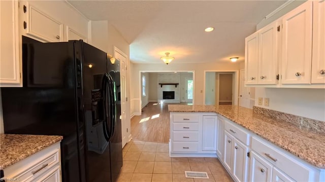 3128 Burke Mill Ct, Winston-Salem, NC 27103 - kitchen featuring black refrigerator with ice dispenser, white cabinetry, a peninsula, light tile patterned flooring, and open floor plan