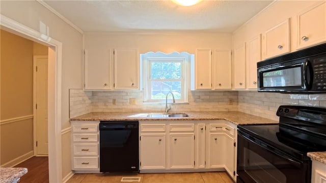 3128 Burke Mill Ct, Winston-Salem, NC 27103 - kitchen featuring black appliances, white cabinetry, light stone countertops, backsplash, and crown molding