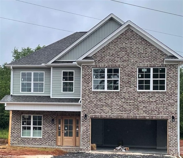 114 Danner Rd, Mocksville, NC 27028 - traditional home featuring brick siding, a porch, a shingled roof, and driveway