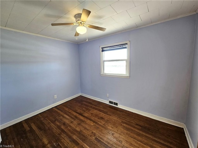 empty room featuring ceiling fan, dark hardwood / wood-style floors, and ornamental molding