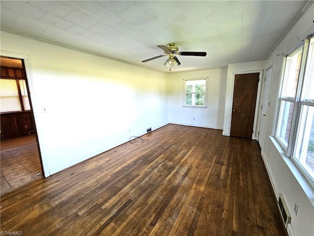 empty room featuring ceiling fan and dark wood-type flooring