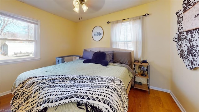 bedroom with hardwood / wood-style flooring and ceiling fan