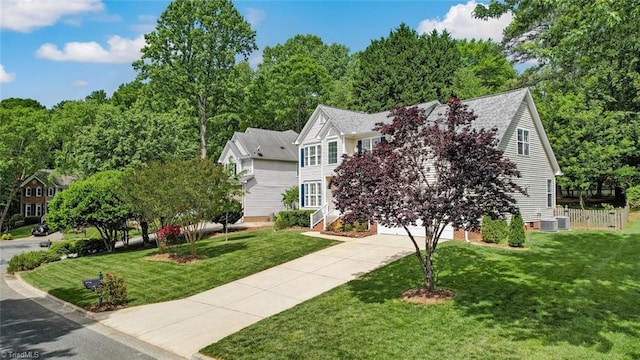 view of front of property featuring driveway, an attached garage, and central AC unit