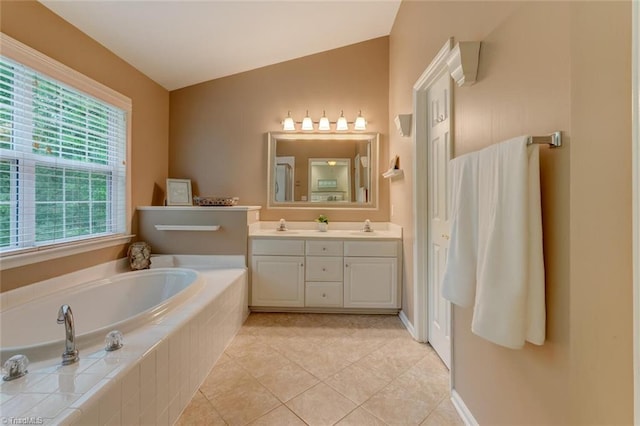 bathroom featuring a bath, tile patterned flooring, double vanity, and vaulted ceiling