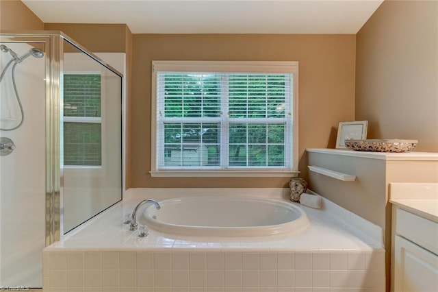 full bath with a shower stall, a bath, and vanity