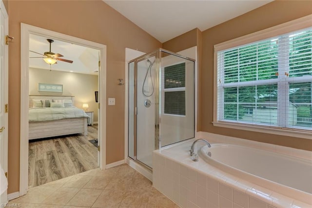 bathroom with ensuite bath, a shower stall, a bath, a ceiling fan, and tile patterned floors