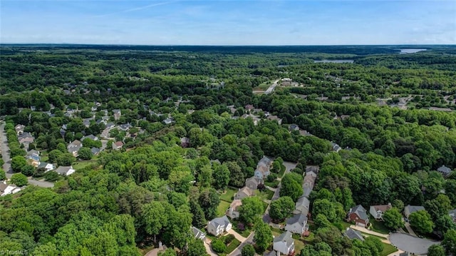 aerial view of property's location featuring a heavily wooded area