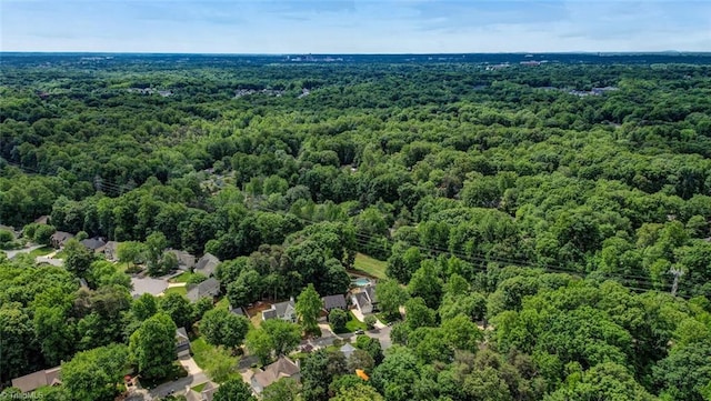 aerial view of property's location with a heavily wooded area