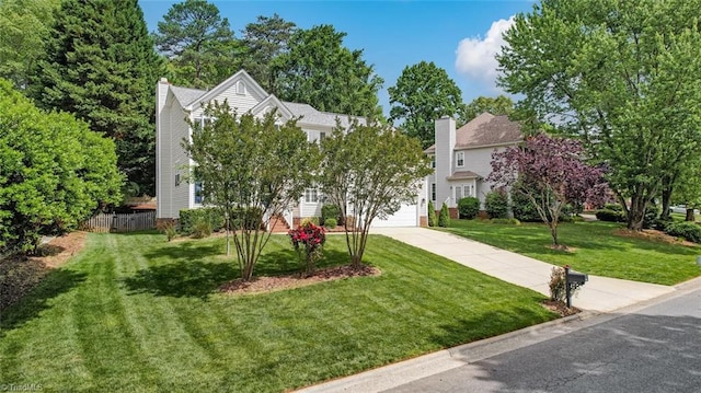 obstructed view of property with driveway and a chimney