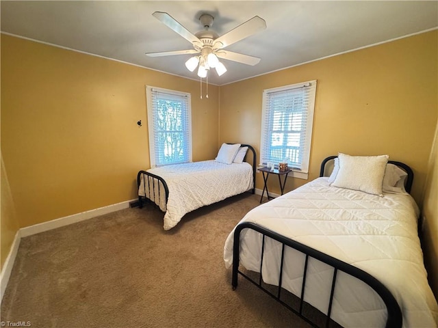 bedroom featuring multiple windows, ceiling fan, and dark colored carpet