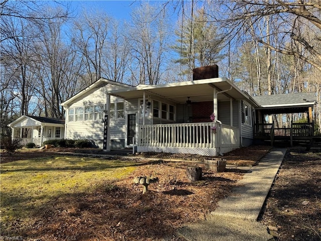 view of front of house with a front yard and covered porch