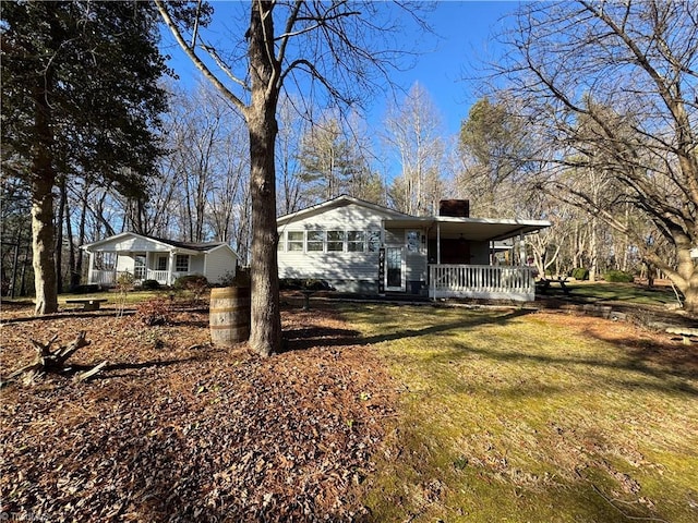 view of front of house with a front yard and a porch