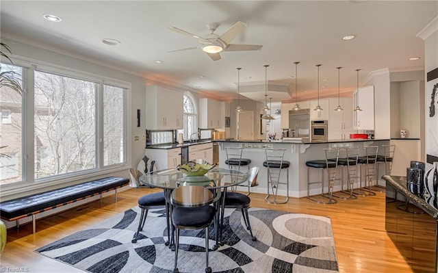 dining area with recessed lighting, light wood-type flooring, ceiling fan, and ornamental molding