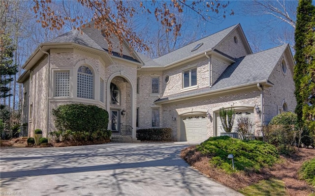 view of front of home with brick siding, driveway, and an attached garage