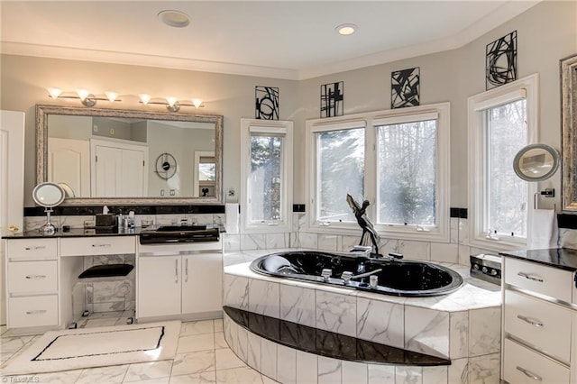 bathroom featuring a bath, marble finish floor, vanity, and ornamental molding