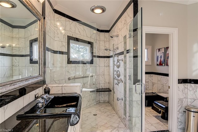 bathroom with tile walls, crown molding, a stall shower, and marble finish floor