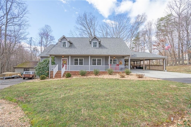 view of front of property with an attached carport, driveway, a porch, a shingled roof, and a front lawn