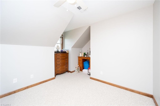 bonus room with vaulted ceiling, carpet flooring, a ceiling fan, and baseboards