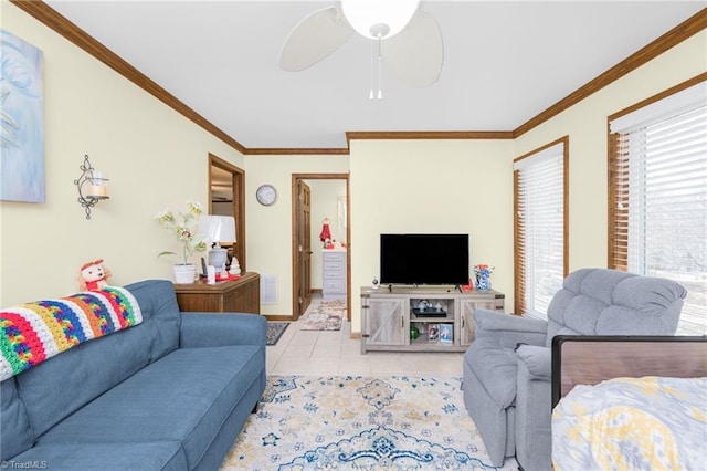 living area with light tile patterned flooring, a ceiling fan, visible vents, and ornamental molding