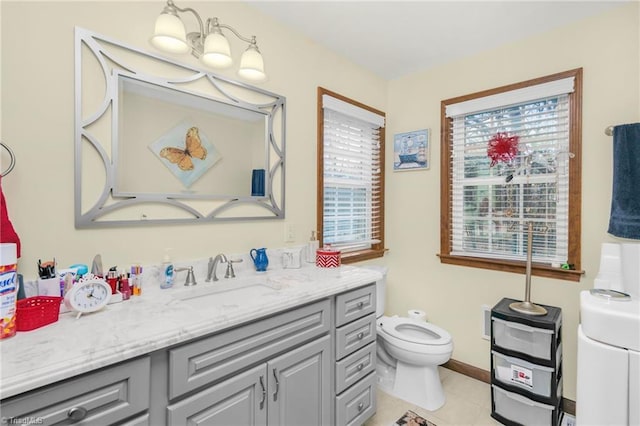 bathroom featuring vanity, tile patterned floors, toilet, and baseboards