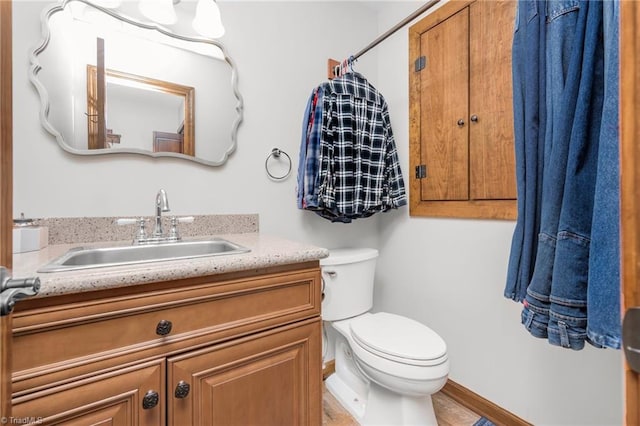 bathroom with toilet and vanity