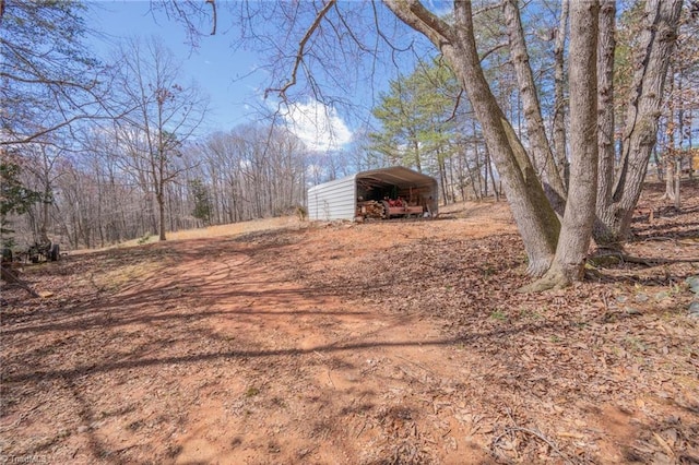 view of yard with a carport and driveway